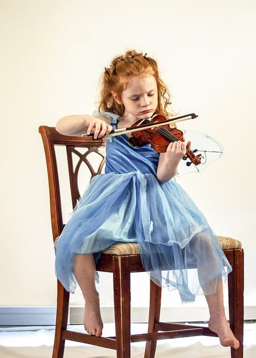 Teaching Music to children: a kid playing violin