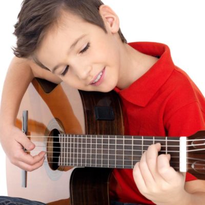 Young boy learning guitar