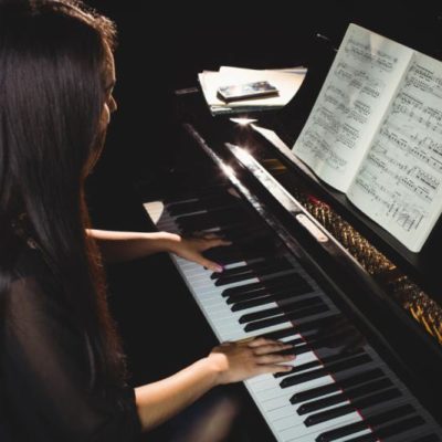 Adult piano player taking piano lessons