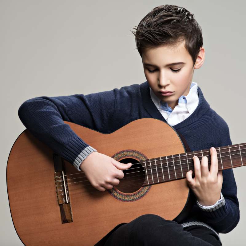 caucasian boy taking classical guitar lessons in Montreal