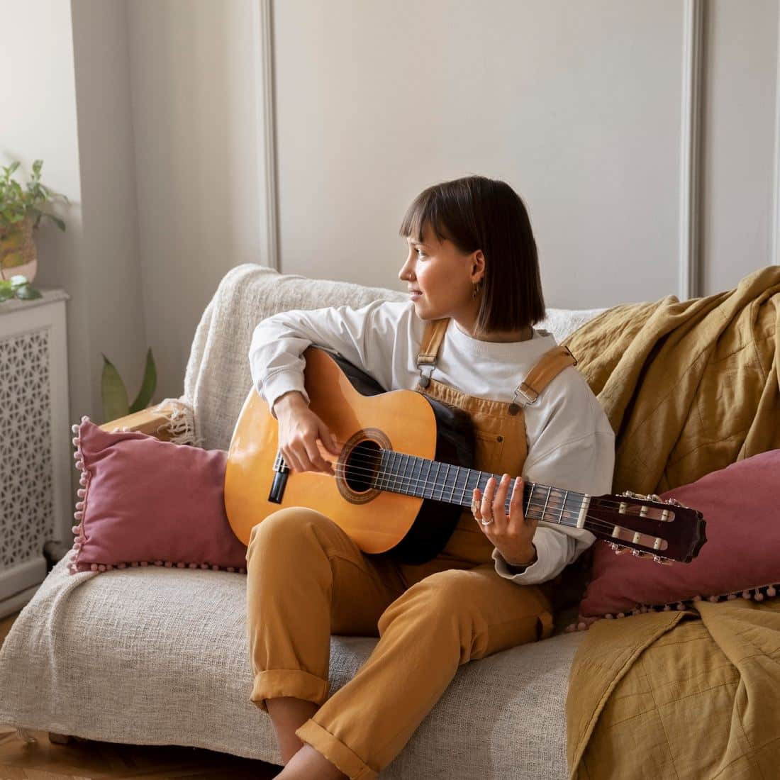 Girl playing guitar at home
in home music lessons